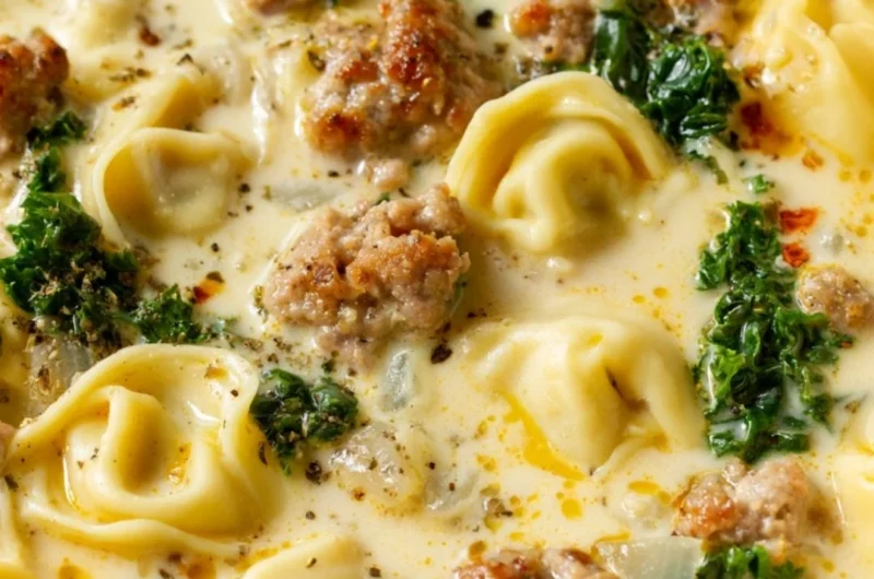 Bowl of delicious Sausage Tortellini Soup with fresh herbs